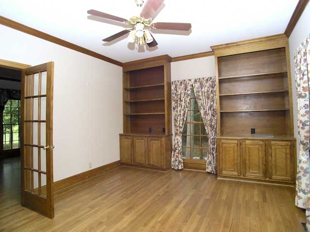Home office with built-in cabinetry and shelving