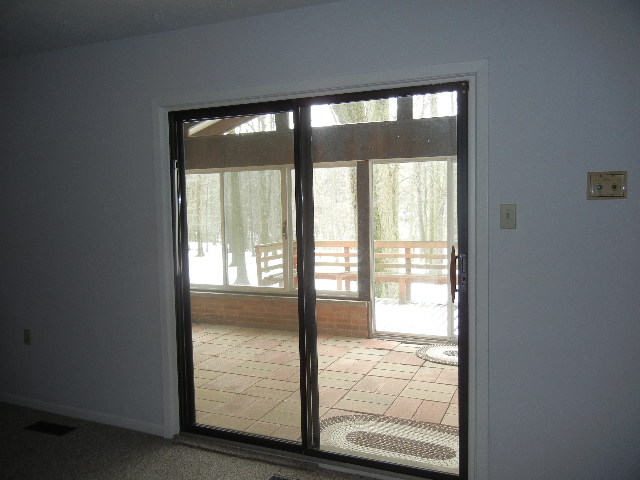 Sliding doors in the family room lead to an enclosed patio and deck.