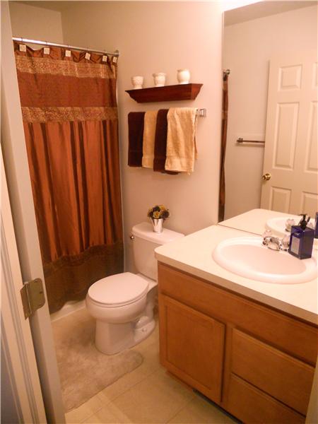 Full bath on second floor in warm neutrals