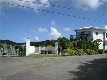 Welcoming Property Entrance with Custom Driveway Gate
