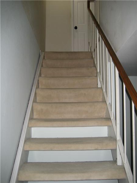 Stairs lead to 3 bedrooms 