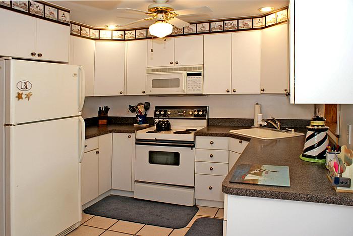 Efficiently designed kitchen opens to a large den/sun room