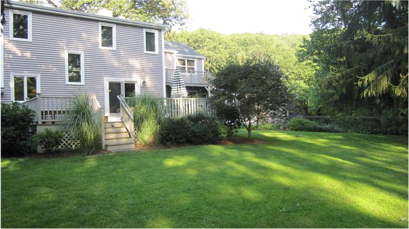 Back of home and backyard view