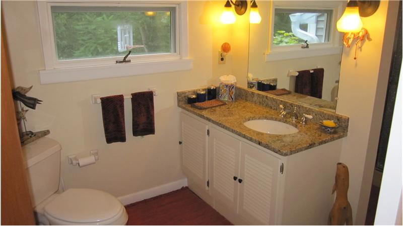 Full bathroom on main level with granite countertop