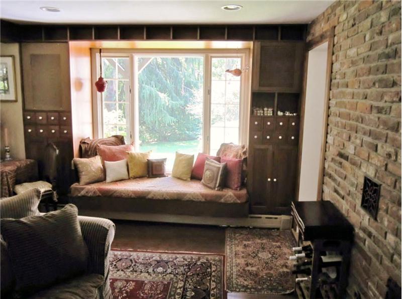 Built-in window seat with speakers and storage surrounding