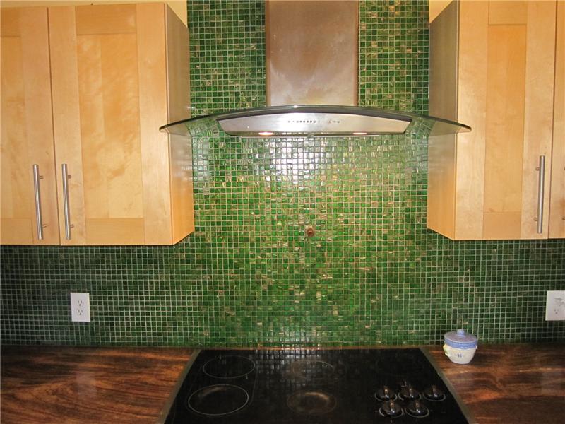Tile backsplash and curved hood