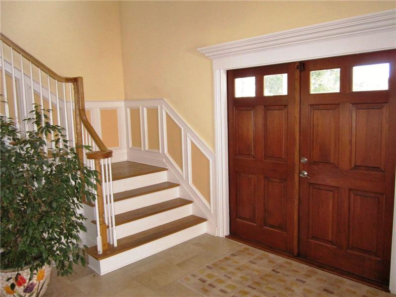 Wood front doors and staircase to upper level