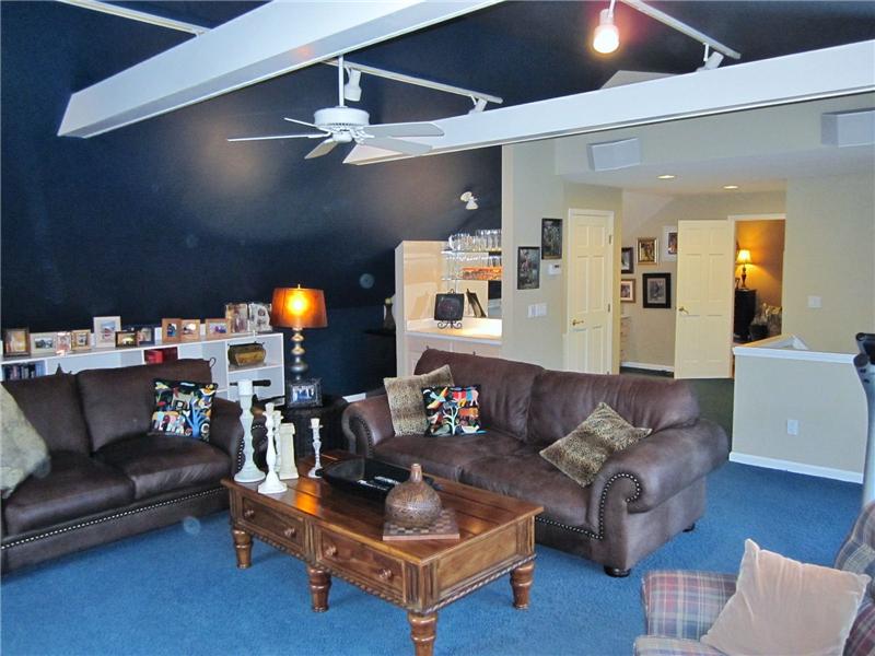 Media Room with ceiling fan and vaulted ceiling